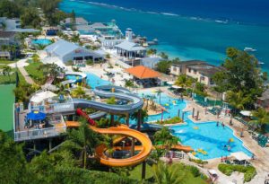 Beaches Resort in Ocho Rios Jamaica showing the waterpark with two or three slides, tubes to enjoy and a beach with crystal blue waters