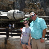 Picture of a Man with his daughter standing in front of the millennium falcon at Hollywood Studios in Orlando Florida